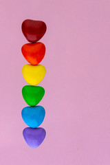 struggle for happiness and equality of sexual minorities: 6 multi-colored candy with the rainbow color of the LGBT flag, short focus, pink background