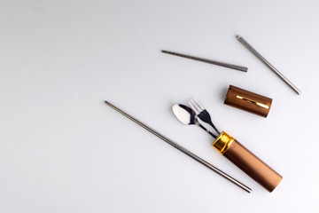 a set of dining items for camping: small spoon and fork, storage case