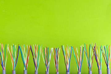 a bunch of colored wires on the background of a light-yellow surface