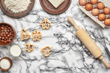 Close-up shot. Top view of a baking ingredients and kitchenware on the marble table background.