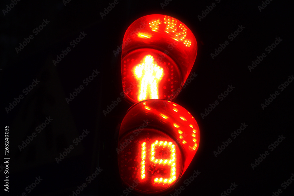Fototapete the red light of traffic light on the pedestrian crossing of a human silhouette and a counter that s
