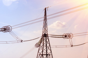 metal poles of the power line against the sky. Landscape with tinting