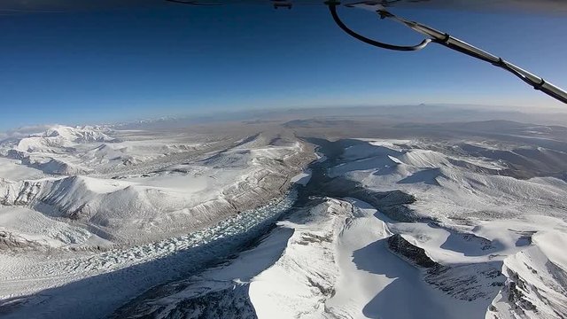 The plane flies over the Himalayan mountains. The tops of the mountains and the glacier are covered with snow. The area of the eight-thousandth Shishabangma. Tibet.