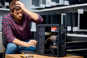 unhappy pensive man looking confused repairing hardware. close up portrait. copy space