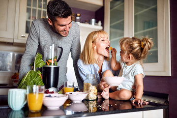Girl feeding her mother in the morning