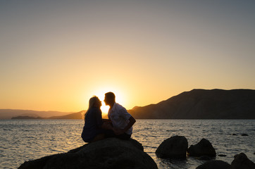 Silhouette of joyful couple by the sea