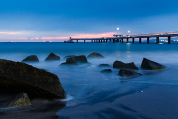 Obraz premium sunrise over bridge in the sea. Burgas bay