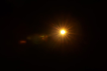 Abstract Natural Sun flare on the black background.