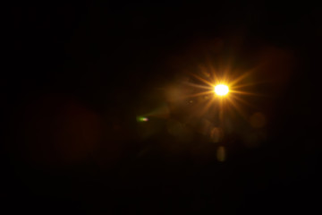 Abstract Natural Sun flare on the black background.