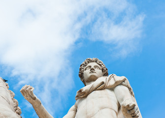 One of the statues of the Dioscuri against blue sky background. The Capitoline Hill. Rome. Italy
