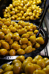Colorful bowls of marinated olives at a food market
