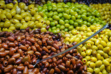 Colorful bowls of marinated olives at a food market