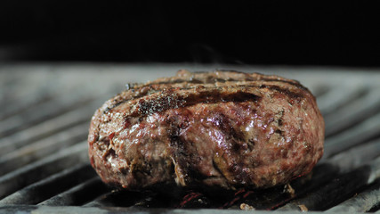 Cooking hamburger. Beef or pork cutlet grilling on grid