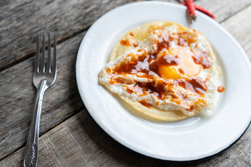 Fried egg with tortilla and hot sauce 