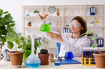 Old female biotechnology chemist working in the lab 