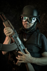 Fototapeta premium Thief, man armed with shotgun and bulletproof vest