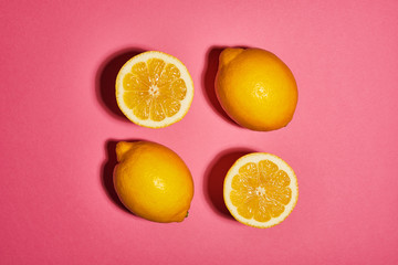 Lemon on pink background. Flat lay, top view, copy space . Food concept.