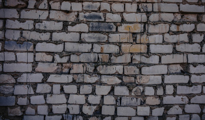 Background of old vintage dirty brick wall with peeling plaster, texture