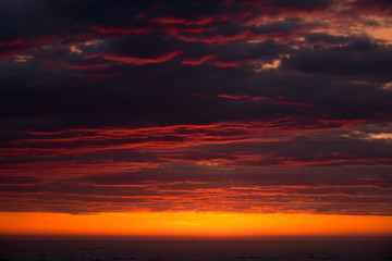 Dramatic dark clouds with red light at sunset