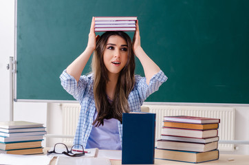 Female student in front of chalkboard 