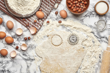 Close-up shot. Top view of a baking ingredients and kitchenware on the marble table background.