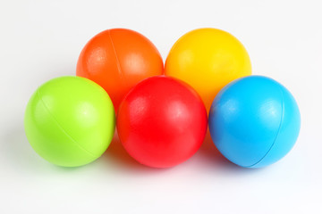 Colored plastic balls on white background