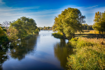 autumn landscape with blue river