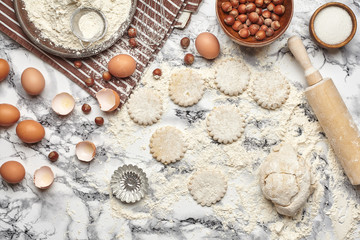 Close-up shot. Top view of a baking ingredients and kitchenware on the marble table background.