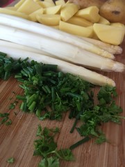 Delicious white Asparagus with potatoes and green herbs