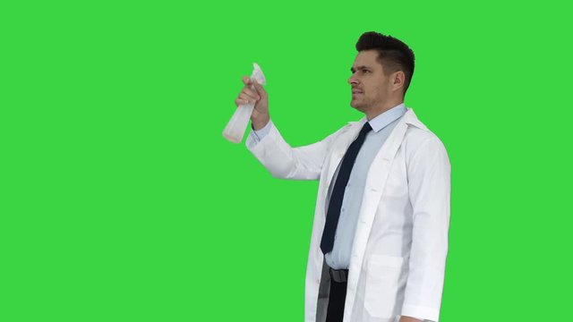 Male worker spraying pesticide on flying insects on a Green Screen, Chroma Key.