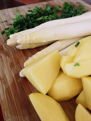 Delicious white Asparagus with potatoes and green herbs