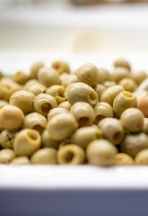 Close up of fresh and organic pitted olives on a luxury Greek buffet with a serving spoon