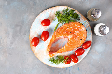 Top view of fresh salmon steak on light blue background