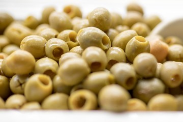 Close up of fresh and organic pitted olives on a luxury Greek buffet with a serving spoon