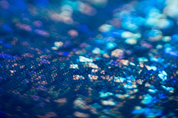 Sparkling blue snake skin. Bokeh abstract background. Defocused glitter glow.