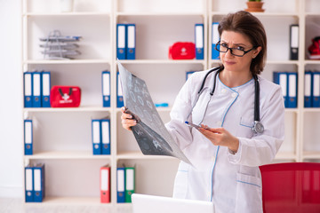 Aged female doctor radiologist in the clinic