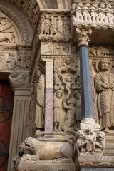 Arles, France. Romanesque figures of saints leaning on fantastic creatures on the west portal of The Church of St. Trophime. Saint Stephen, Saint Andrew