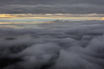 Obraz premium Abstract photograph above the clouds, sea of clouds effect, flying through the sky, aerial view, white puffy clouds and blue sky. Low pressure front atmospheric effect, cloudscape, cloudy weather