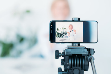 Woman vlog. Cosmetics and beauty. Female on smartphone screen. Hobby and lifestyle. Video shooting equipment.