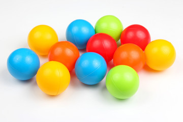 Colored plastic balls on white background