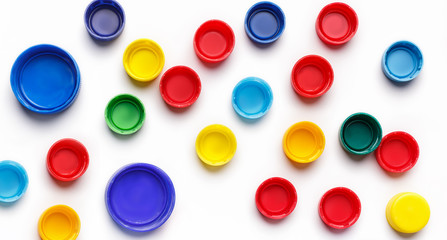 Colored plastic bottle's covers on white