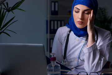 Arab female doctor working in the clinic at night 