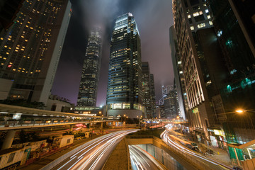Fototapeta na wymiar Lights streak of traffic with modern buildings in the city night.