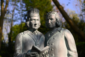 Fototapeta na wymiar The Brothers Grimm as statues in a park