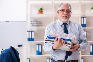 Aged male employee working in the office 