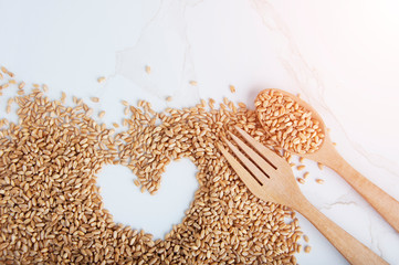 Natural of healthy with wheat gains. Wooden Spoon filled with Wheat grains.