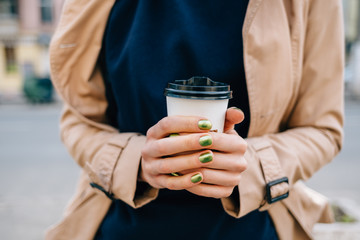 Close-up female's hands with green manicure