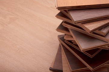 Materials of interior design. wood texture floor Samples of laminate and vinyl floor tile on oak wooden Background for new construction or renovate building