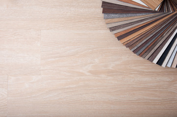 Obraz na płótnie Canvas selection color for interior decorating. wood texture floor Samples of laminate and vinyl floor tile on oak wooden Background for new construction or renovate building or home renovate.