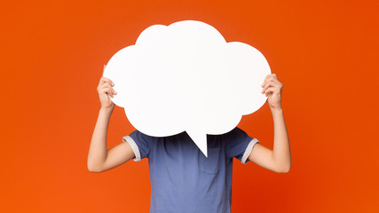Little boy holding an empty speech bubble in front of his head